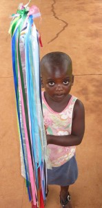 A child carries a Rainbow Stick, Tsangano, Mozambique
