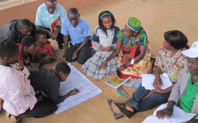 Health workers and teachers working with children to design nutrition education strategies.