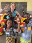 Clare with children in classroom having fun copy